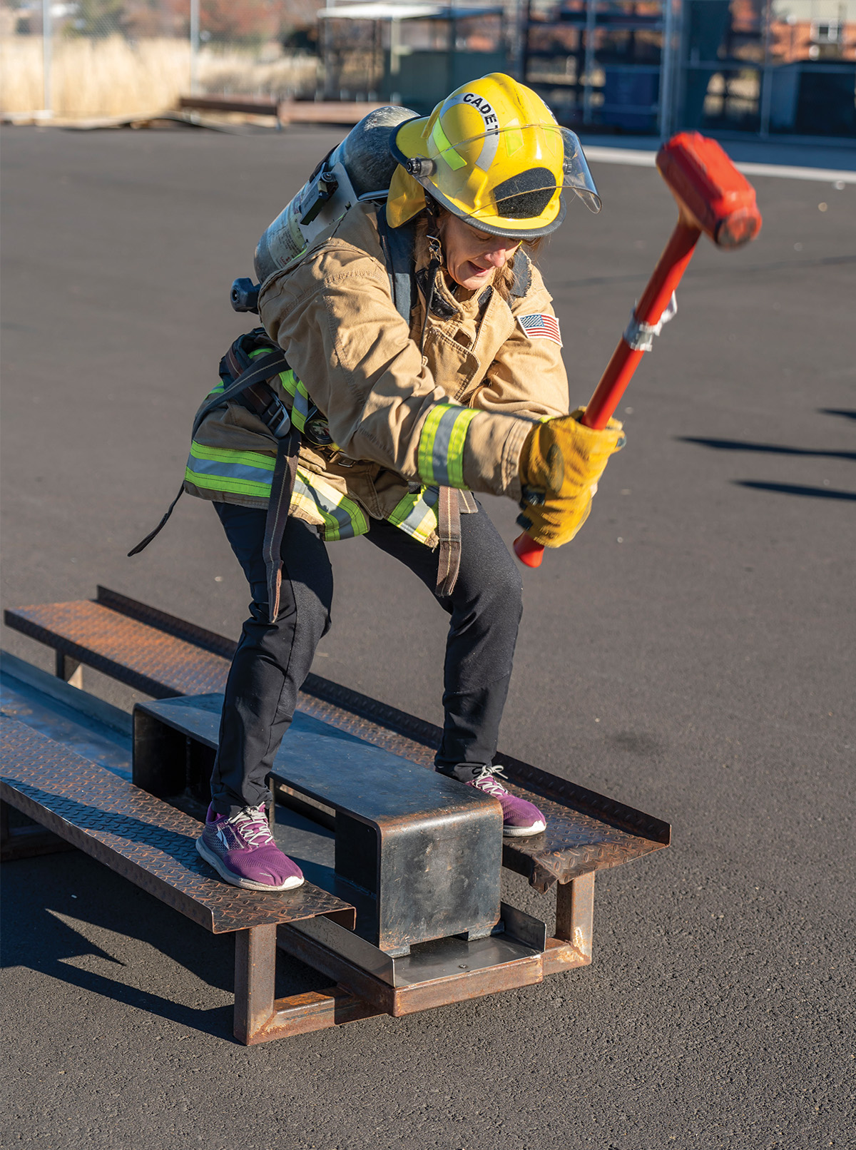 Caleb Herrera/KCC photo Members of the Klamath Falls emergency services try their hand at pounding a block of steel with a sledge hammer as part of the strength and endurance tests on the Klamath Community College campus  as part of the Movember men’s health awarness events.